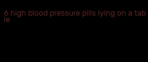 6 high blood pressure pills lying on a table